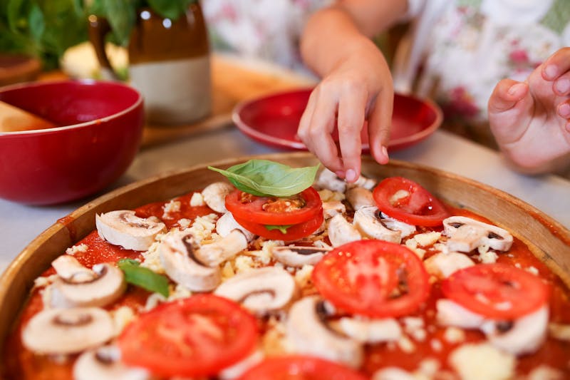 Guests participating in a hands-on pizza making class